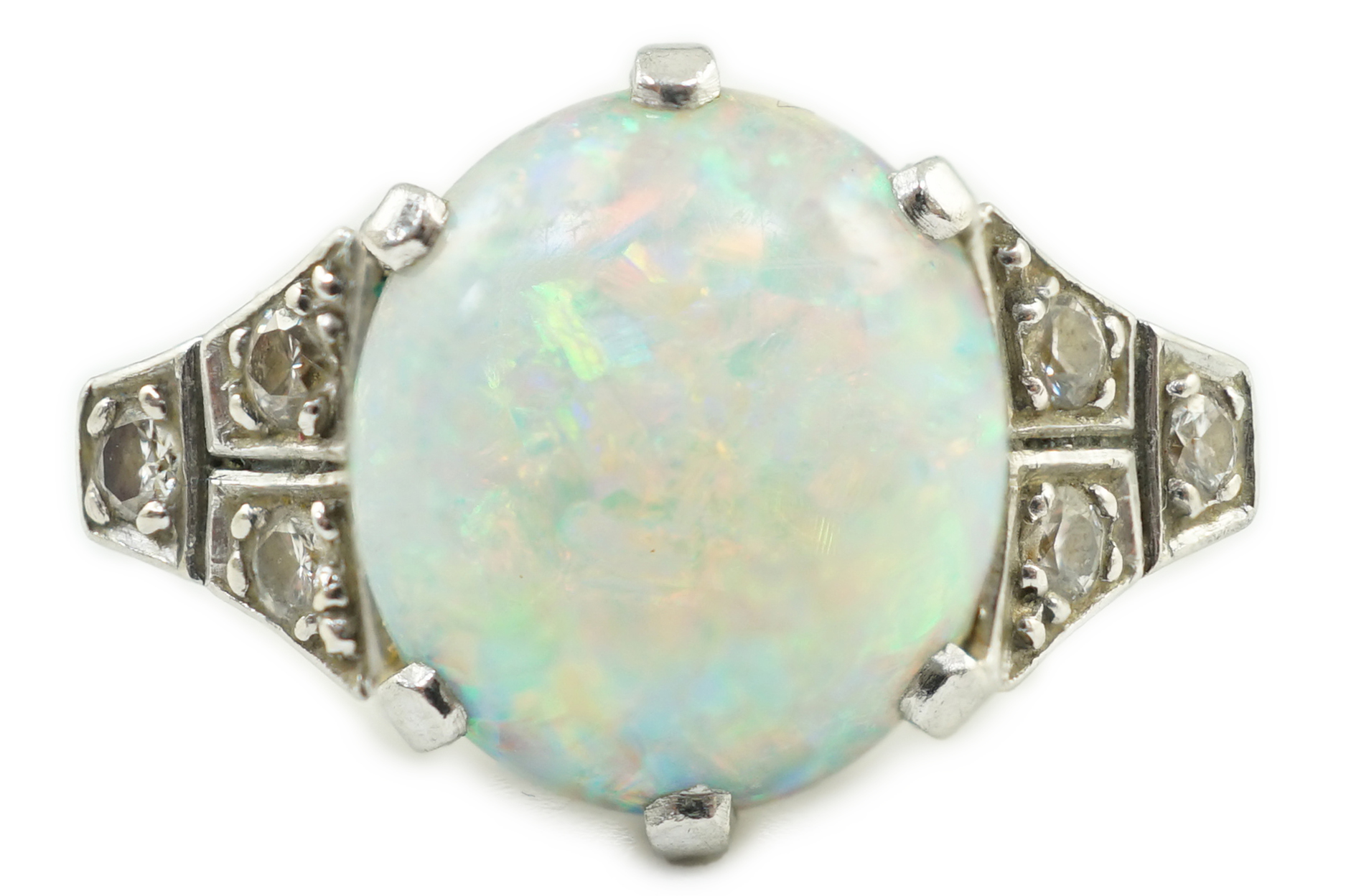 An 18ct white gold, platinum and single stone white opal set dress ring, with six stone diamond set shoulders